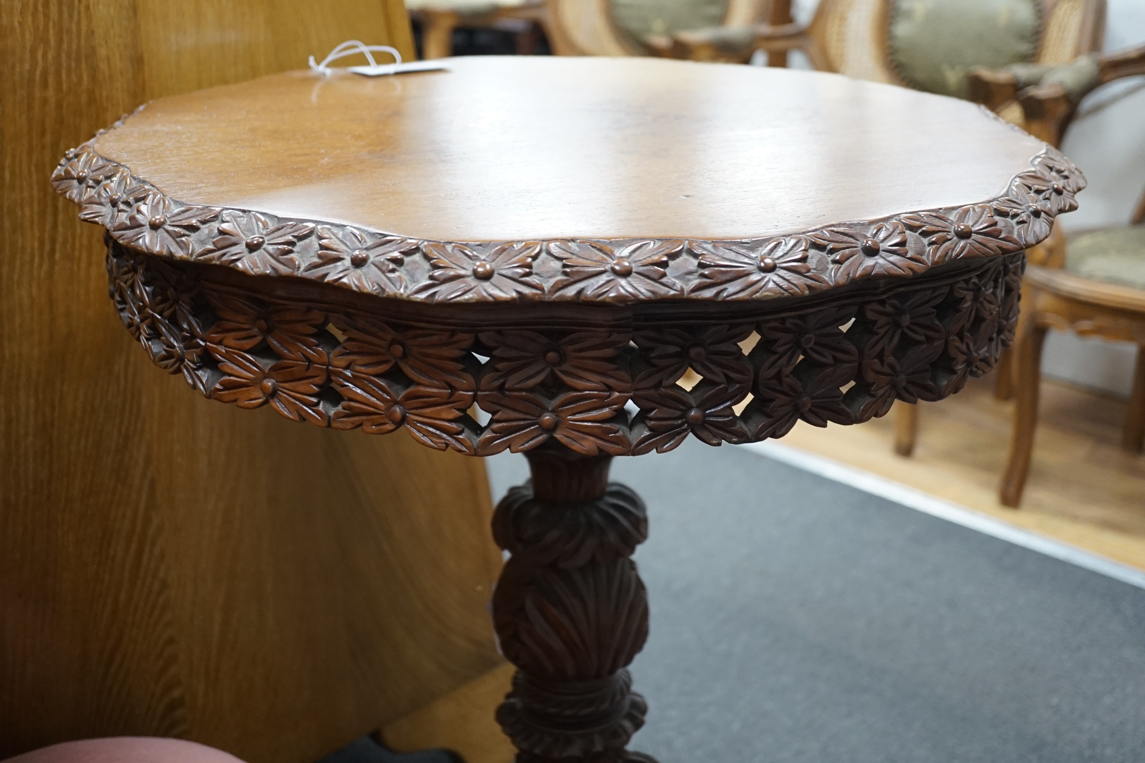 A Burmese carved hardwood circular occasional or centre table, diameter 57cm height 74cm, together with a similar side chair and foot stool